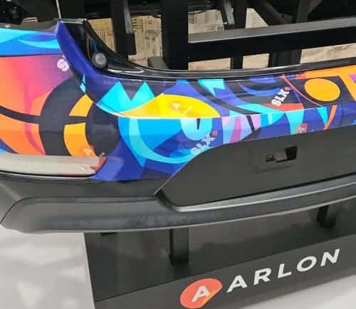 Blue Sky Signs specialists are installing a custom Arlon vinyl wrap on a grey car bonnet at the Arlon Experience Centre.
